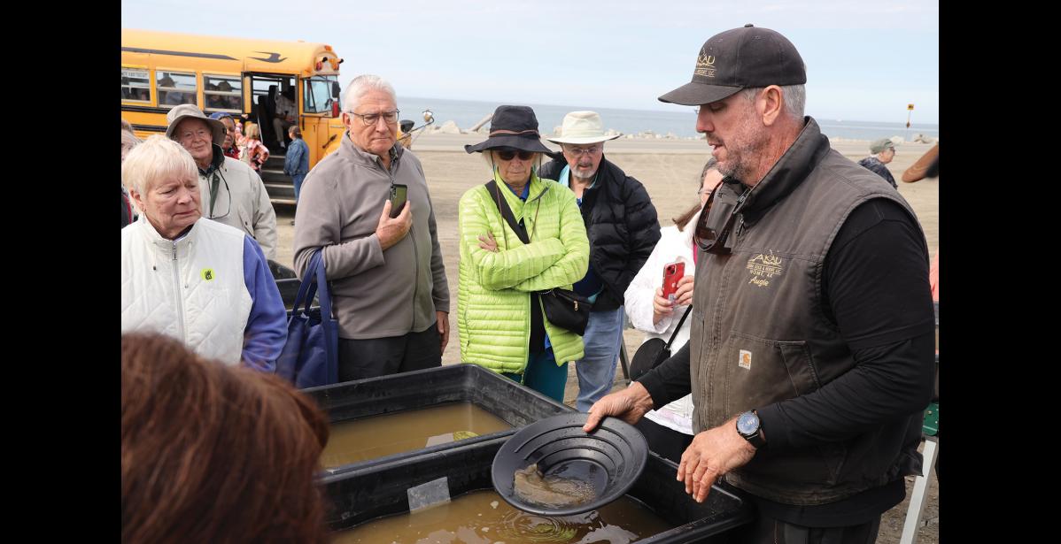 Photo by Colin Warren GOLD – Augie Krutzsch, owner of Alaska Gold & Resort, demonstrates panning techniques to cruise ship guests, on Friday, June 21.