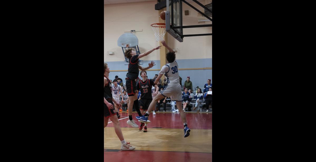 IN MOTION – Barak Wagle of the Wasilla Warriors and Cohen Booth of the Nanooks jump for the ball at the Ruckus at the Rec on Friday, January 23.