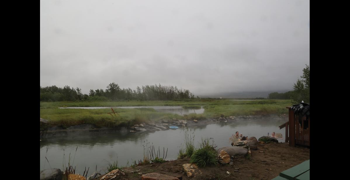 Photo by Anna Lionas FOGGY SPRING–Three guests soak in the hot spring at Pilgrim on a foggy Sunday morning, August 11.