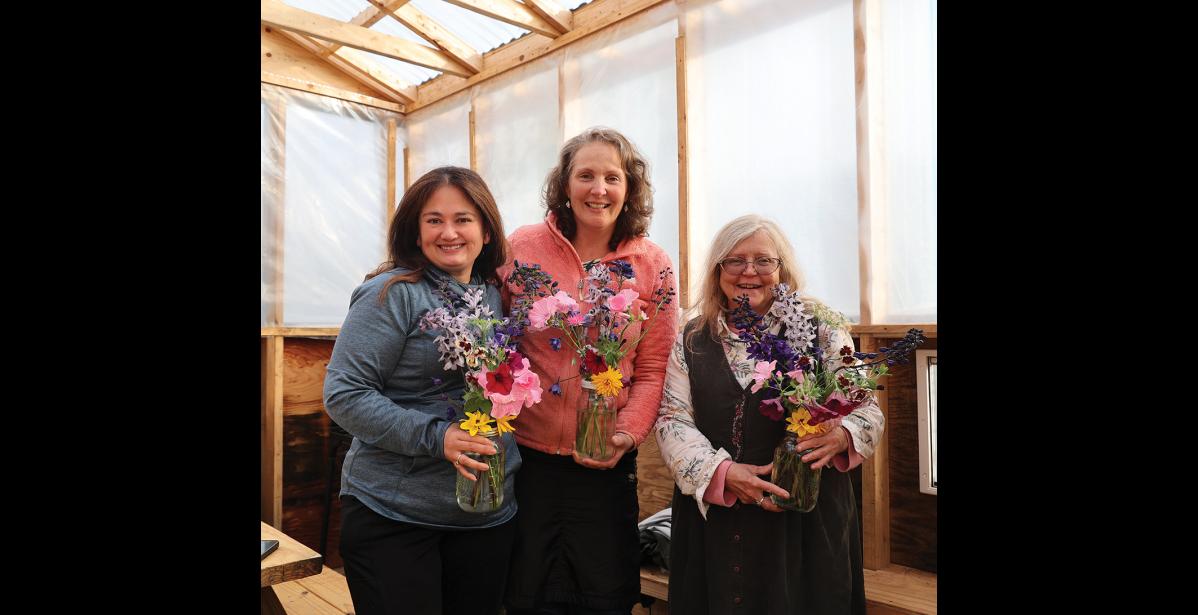 Photo by Anna Lionas GARDEN PARTY— Nome Garden Tour organizers Kim Knudsen, Angela Hansen and Cheryl Thompson at the potluck concluding the event on August 18.