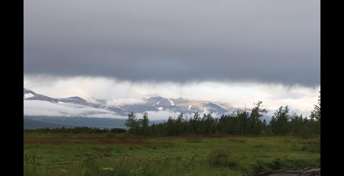 Photo by Anna Lionas SKY OPENS UP–A view of the Kigluiak Mountains is available for visitors of Pilgrim Hot Springs on August 11 during a brief moment when the clouds part on a rainy morning.