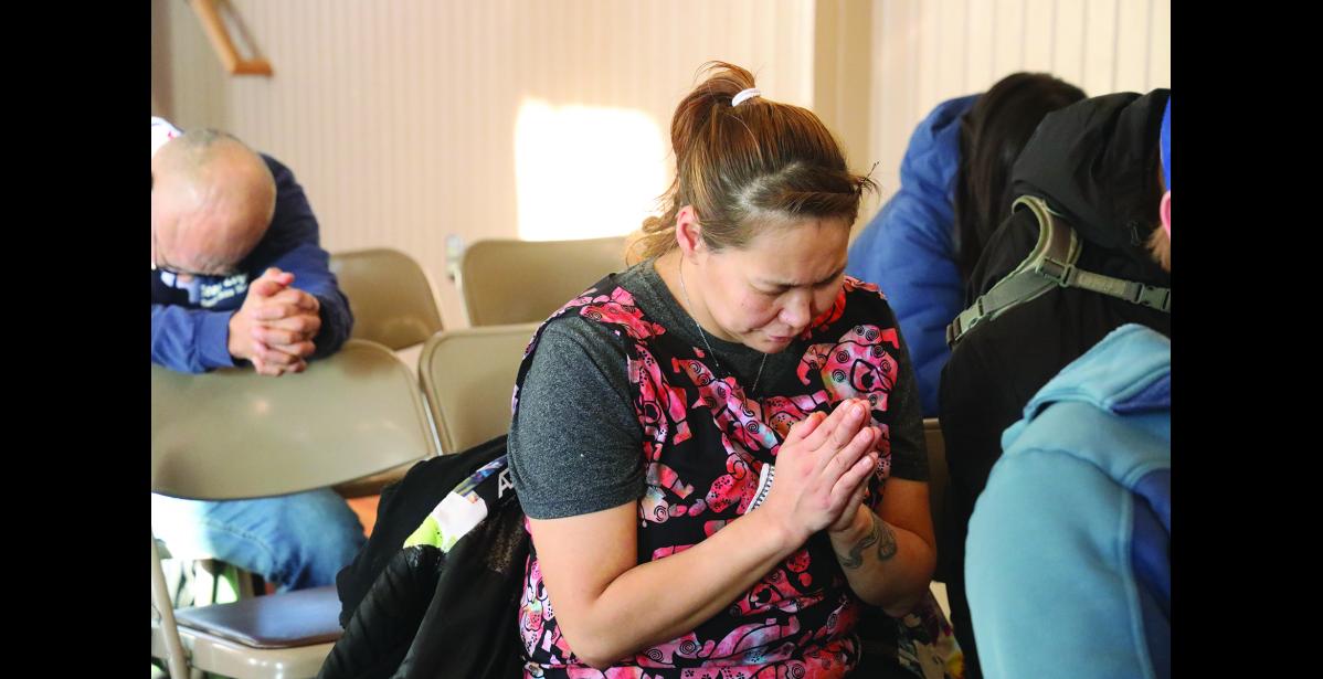 Photo by Laura Robertson Alexandria Okpealuk is deep in prayer.