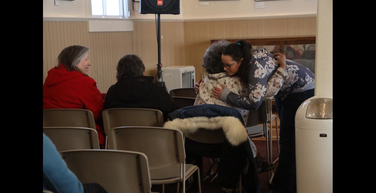 Photo by Laura Robertson Pastor Amanda Snyder hugs Arlene Soxie during a prayer vigil on Friday.