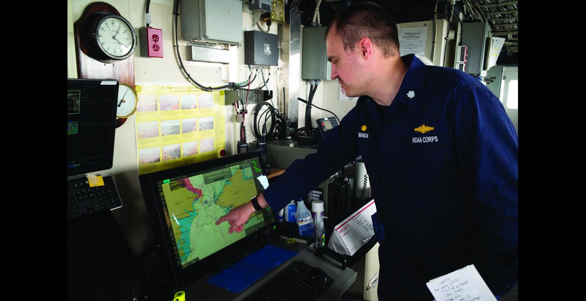 ELECTRONIC CHART MONITOR— Fairweather Commander Damian Manda points to the ECDIS, which stands for electronic chart monitor in the bridge of the Fairweather. Photo by Nils Hahn
