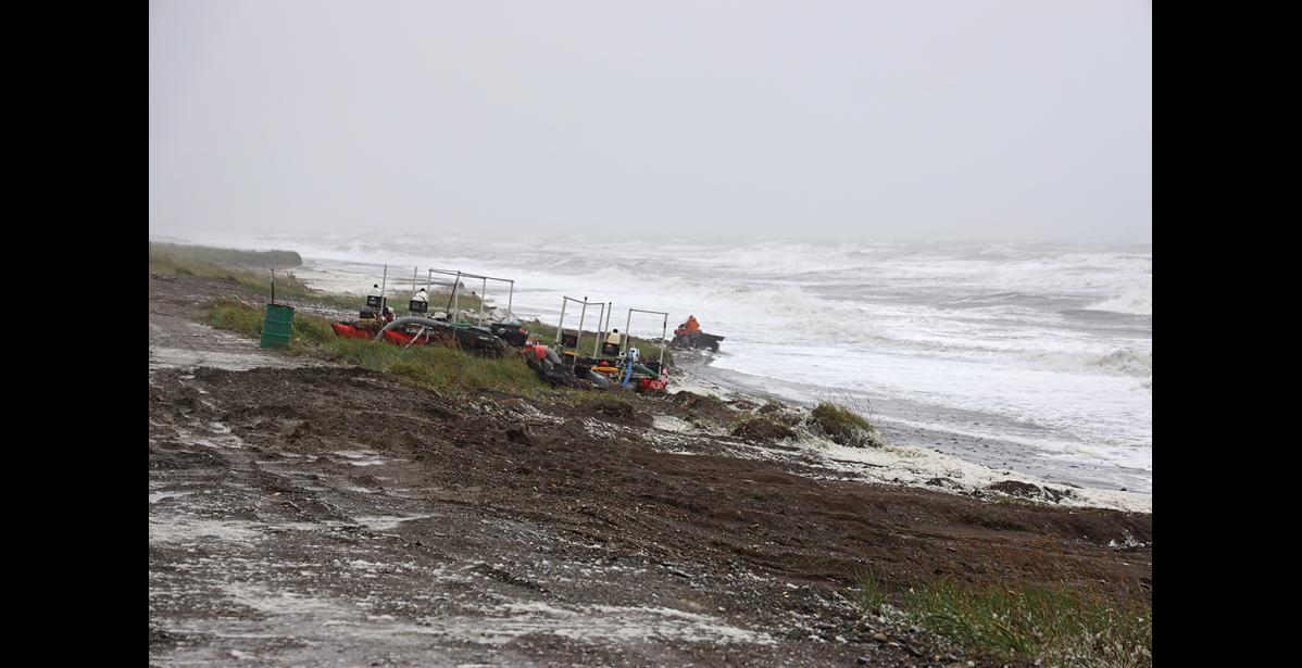 Photo by Nils Hahn STORMY— Gold mining dredges were brought up high as high surf pounded East Beach on July 28, setting the all-time rain record for that day with a precipitation of 1.47 inches.