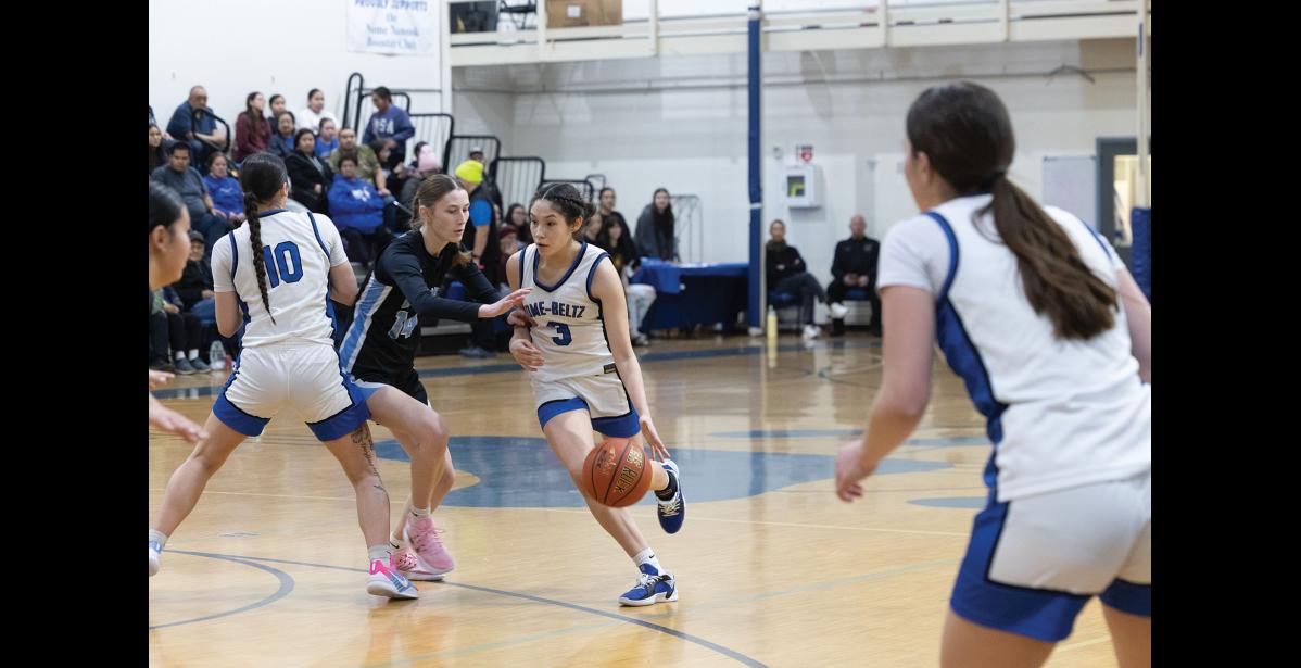 Photo by Ariana Crockett O'Harra LOCKED IN – Alora Stasenko dribbles past a Valdez Buccaneer defender at the Subway Showdown in the Nome-Beltz Middle High School Gymnasium on Saturday, January 10.