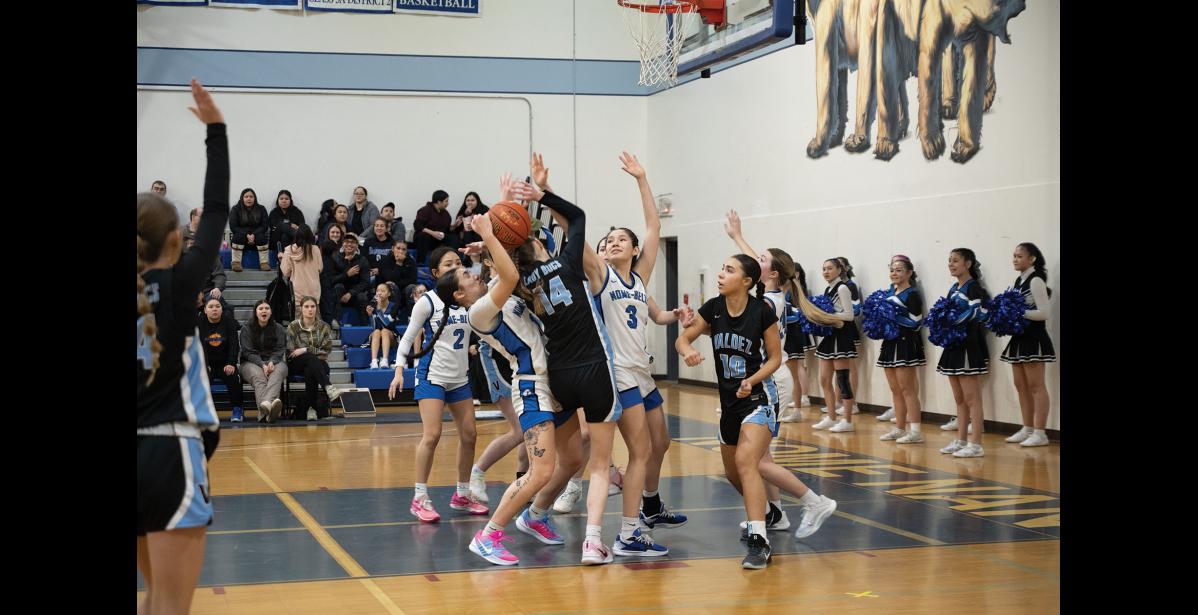 Photo by Ariana Crockett O'Harra IN THE SCRUM – BrookLynn Crowe and Alora Stasenko fight for the ball against the Valdez Buccaneers at the Subway Showdown in the Nome-Beltz Middle High School Gymnasium on Saturday, January 10.