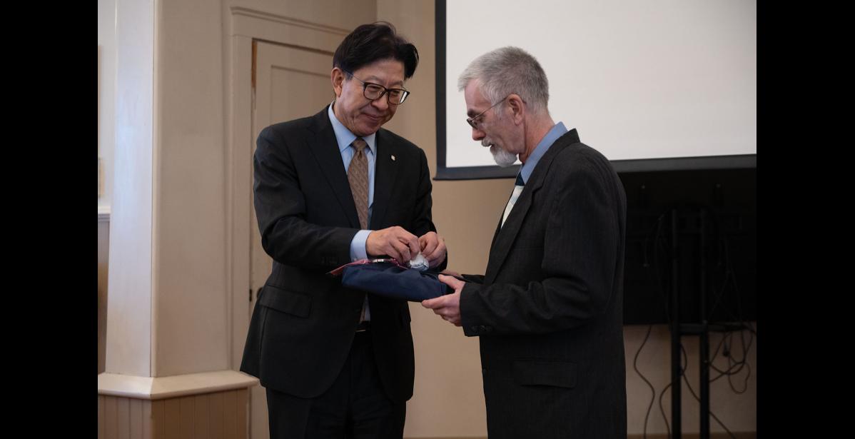Photo by Ariana Crockett O'Harra GIFT-GIVING – Busan Mayor Heong-Joon Park presents Nome Mayor Kenny Hughes with a gift at Old St. Joe’s on Tuesday, January 6.