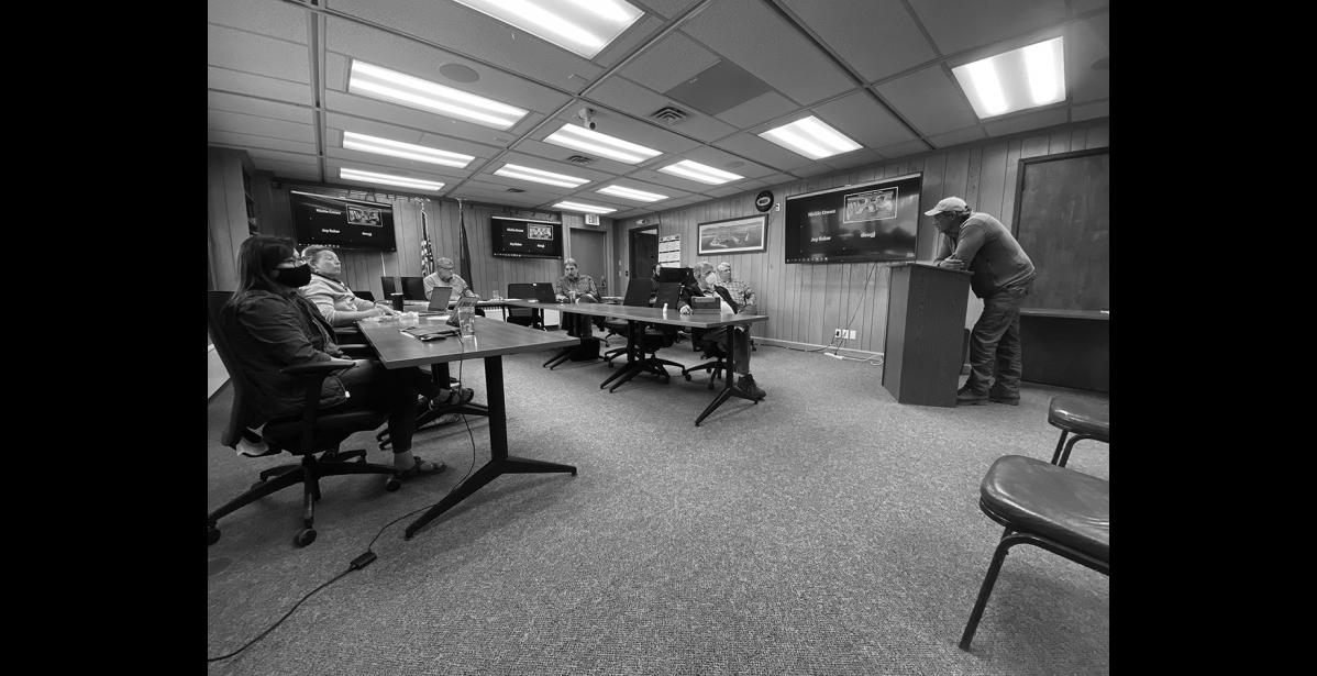 Photo by Diana Haecker Miner Shawn Pomrenke, left, addresses the Nome Common Council with the request for a permit to mine in the Moonlight Wells protective area.
