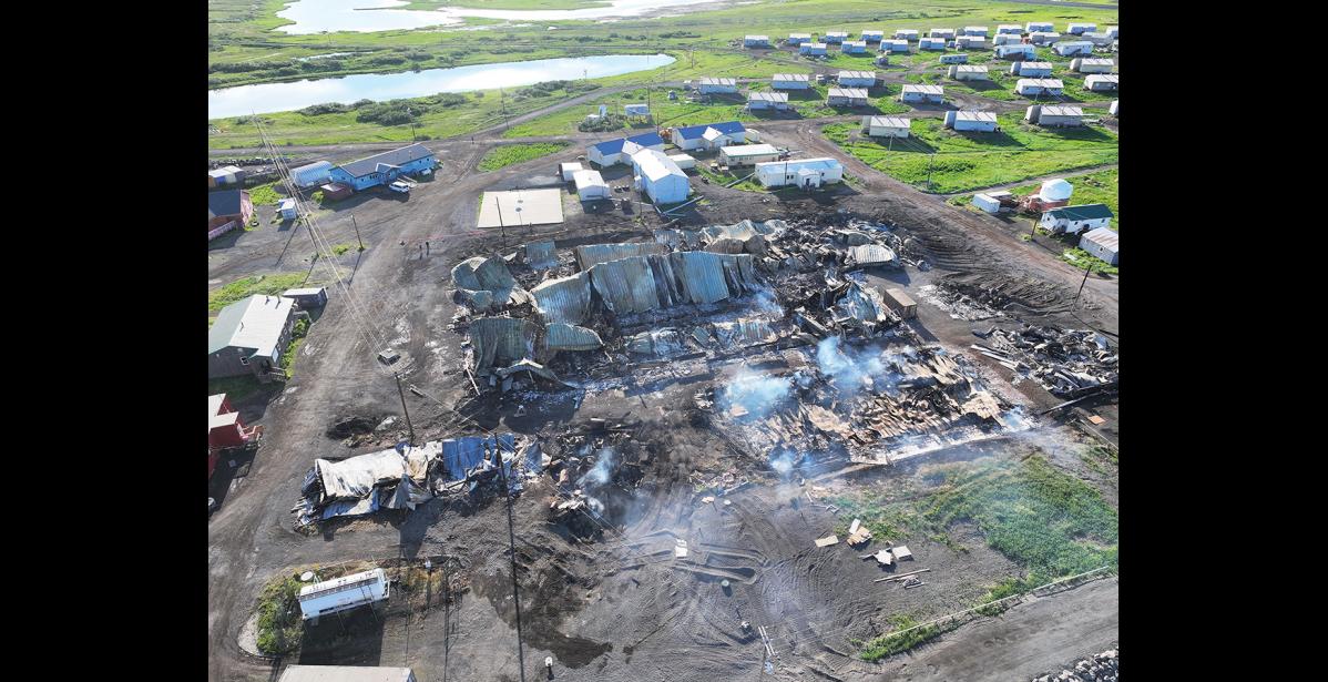 Photo courtesy Tapraq Rock/Dylan Saunders DESTROYED—Noxious smoke still rises from smoldering debris four days after a fire destroyed 10 school buildings and damaged seven others.