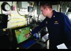 ELECTRONIC CHART MONITOR— Fairweather Commander Damian Manda points to the ECDIS, which stands for electronic chart monitor in the bridge of the Fairweather. Photo by Nils Hahn
