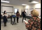 ITS OFFICIAL— Nursing instructor Flo Kassly leads graduates Alyse Morris, Kallie King, Daniel Hobbs and their remotely participating classmates in an oath as part of their graduation ceremony.