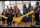 RIBBON CUTTING— Norton Sound Health Corporation board members Berda Willson of Native Village of Council (seated), Charlie Brown of Chinik Eskimo Community, Matilda Hardy of Native Village of Shaktoolik, Wilma Amaktoolik of Village of Solomon, Tony Haugen board chair of Native Village of Unalakleet, Rosemary Otton of Native Village of Koyuk, Frederick Murray of Native Village of Elim, and Joanne Oxereok of Native Village of Wales celebrate as Quyanna Care Center resident Sarah Kakaruk cuts the ceremonious ribbon to QCC's expanded facility, on Thursday, September 17. Photo by Ariana Crockett O'Harra
