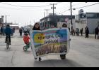 PARADE – Sophia Piscoya and Tegan Oleson of Girl Scout Troop 352 carry the Midnight Sun Festival banner during the Midnight Sun Parade on Saturday, June 20 on Front Street. Photo by Ariana Crockett O’Harra